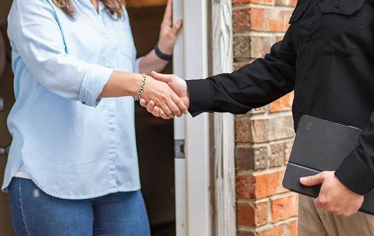tech shaking hands with a homeowner