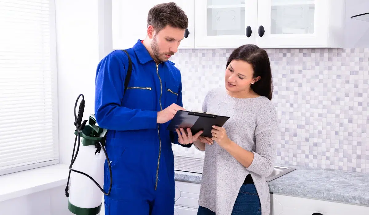 Pest Control Worker Showing Invoice To Tenant