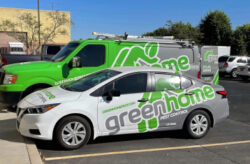 The vehicle fleet for Green Home pest control with a white sedan and a green truck in the background